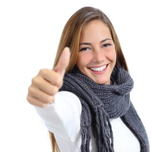 smiling young woman giving the thumbs up sign